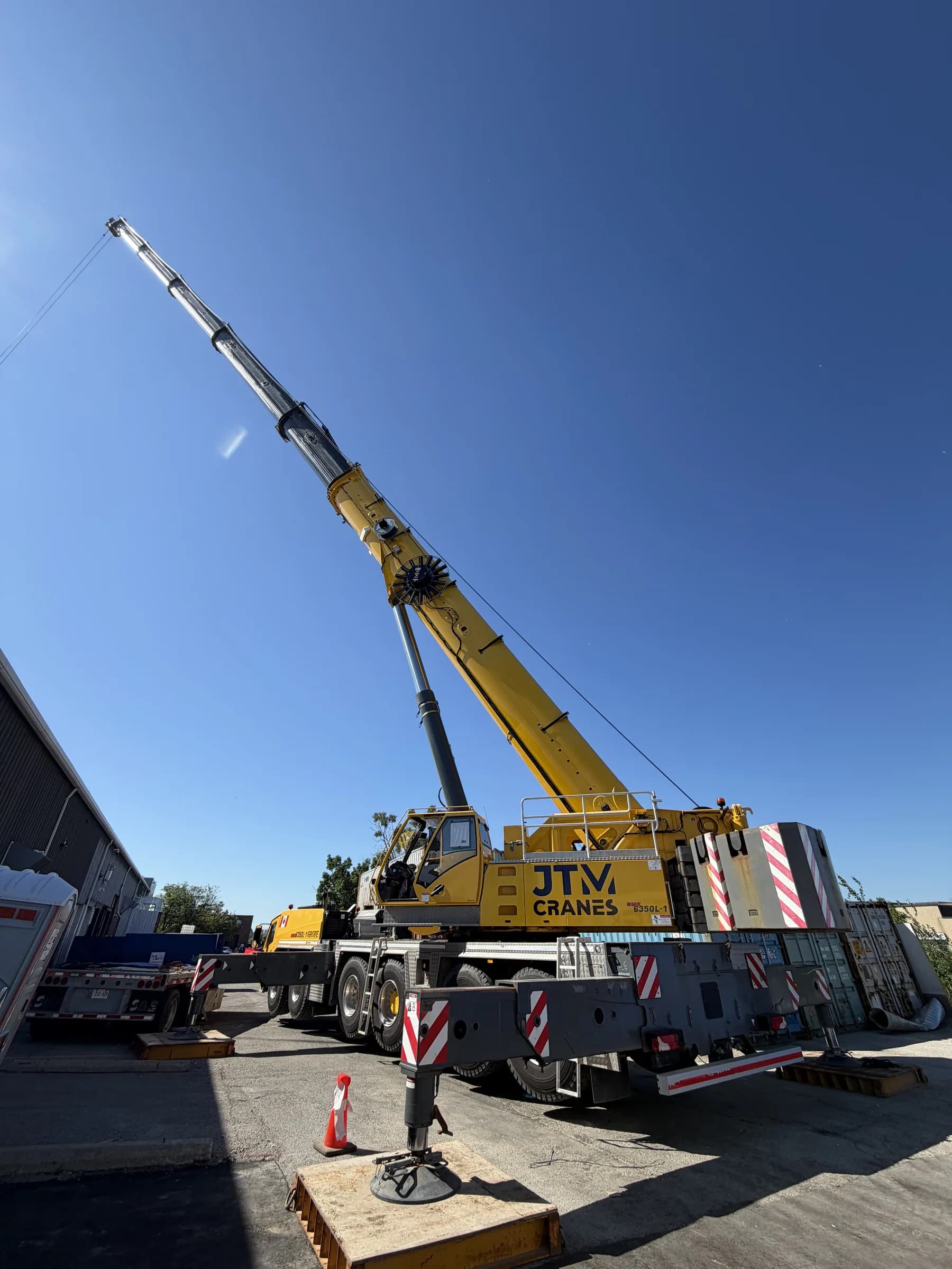 JTM Cranes yellow Grove all terrain crane set up with the boom raised