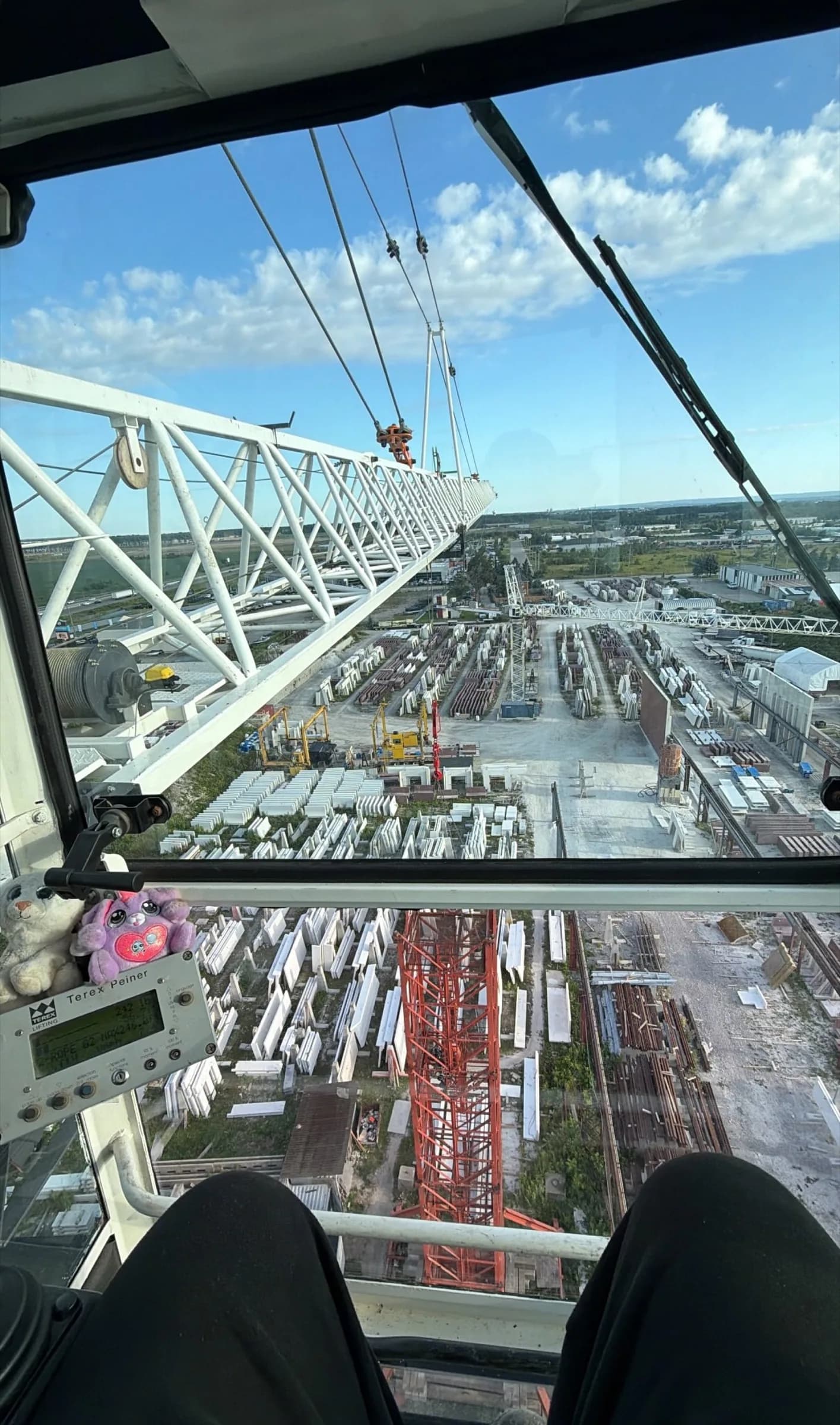 View from a tower crane cab looking down over the jobsite below